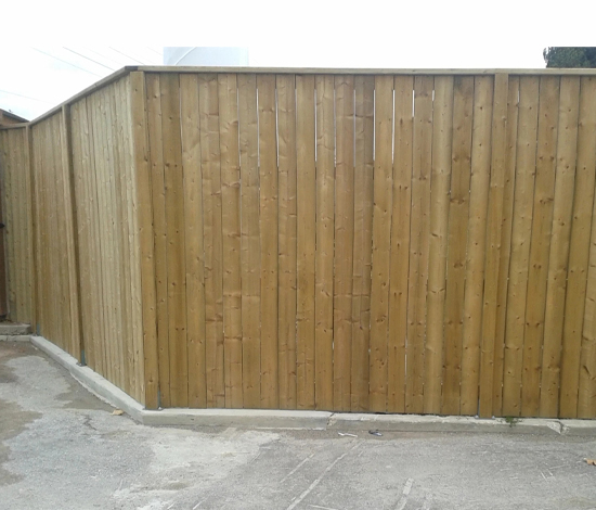 wood fence mounted on curb