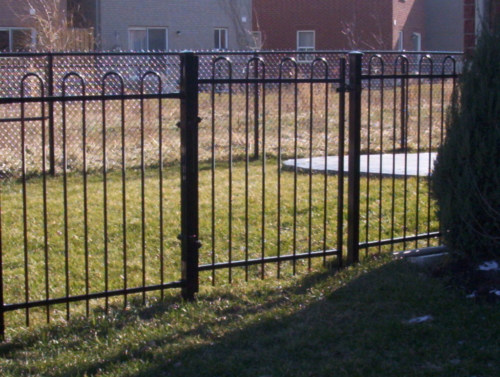 Ornamental iron fence in front of chain link fence